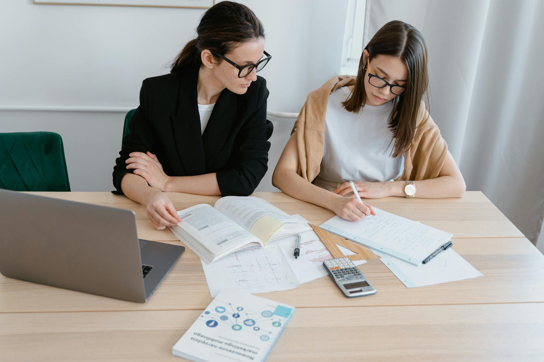 Professional woman working on laptop in modern office environment
